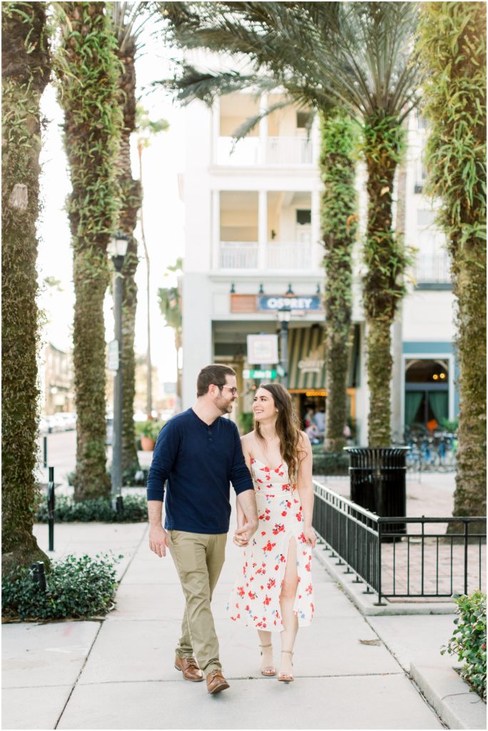couple walking with palm trees