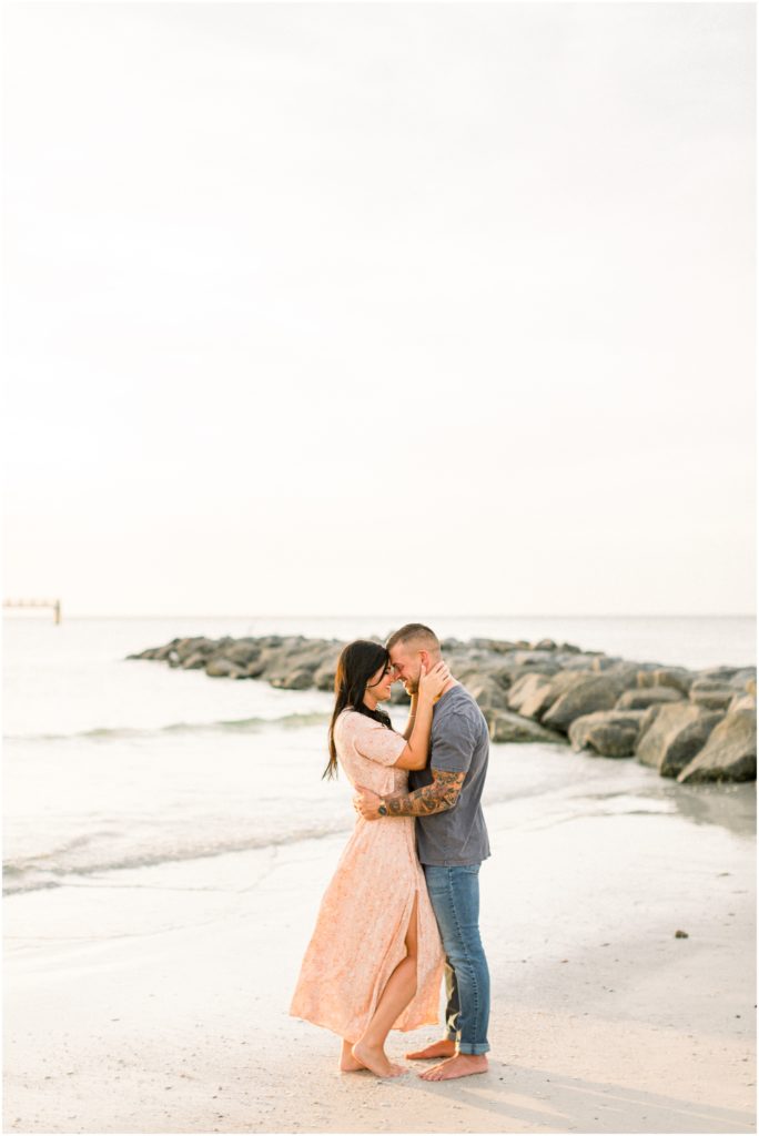 couple touching foreheads on beach