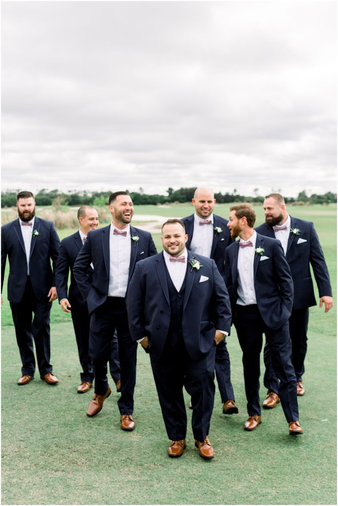 groomsmen walking in navy suits