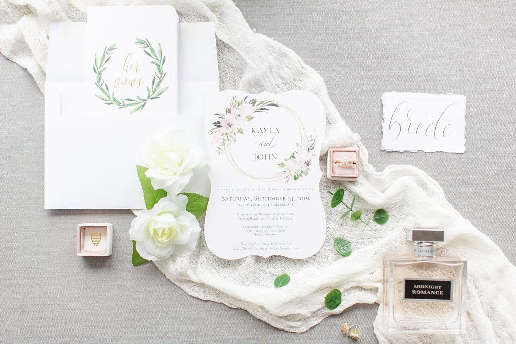 styled wedding details with invitations and rings