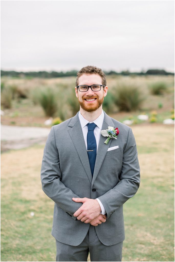 groom with grey suit and navy tie