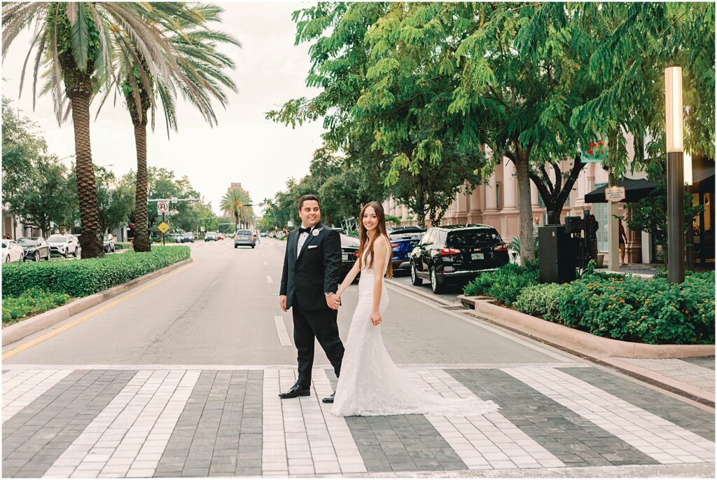 walking across street with bride and groom