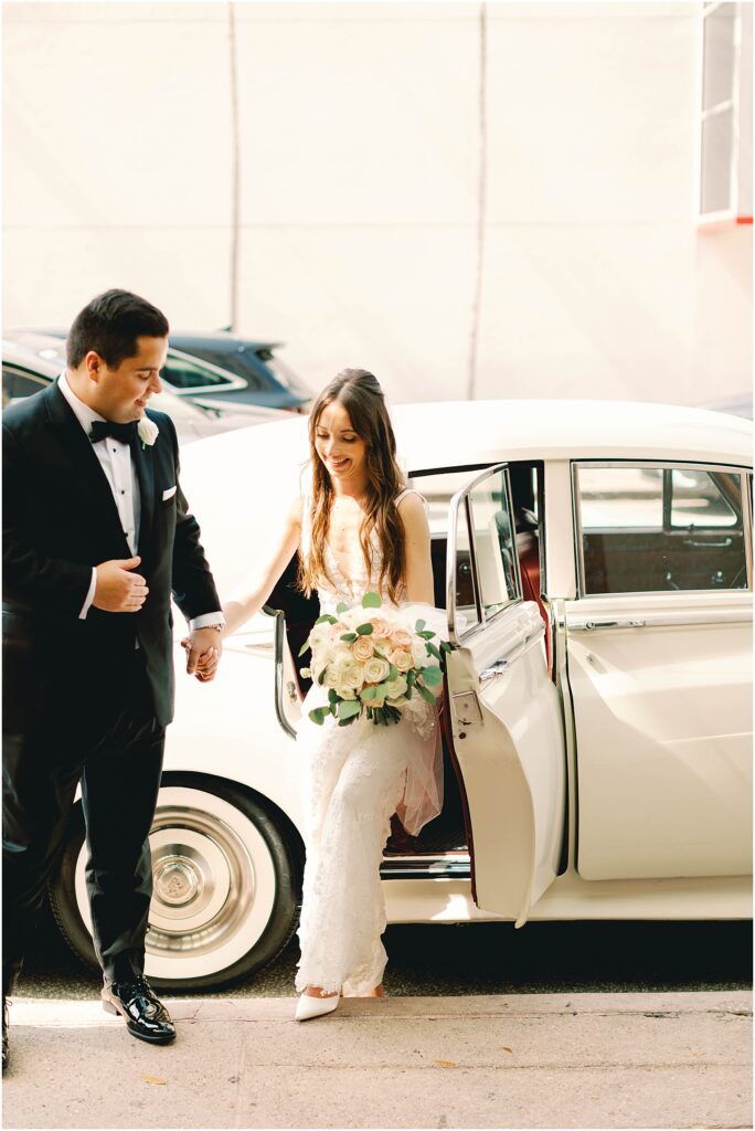 bride and groom get out of vintage car